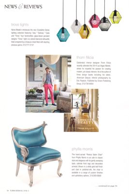 Advertisement for furniture with a blue chair, colorful pendant lights, and a person in a room.